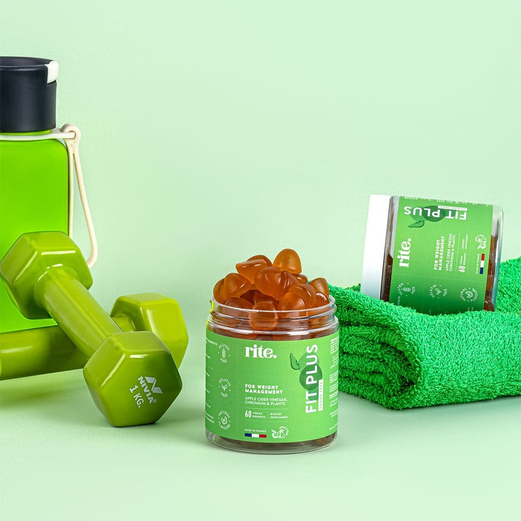 A jar of Rite FIT PLUS Sugar-Free Gummies sits on a green background next to two dumbbells and a towel.