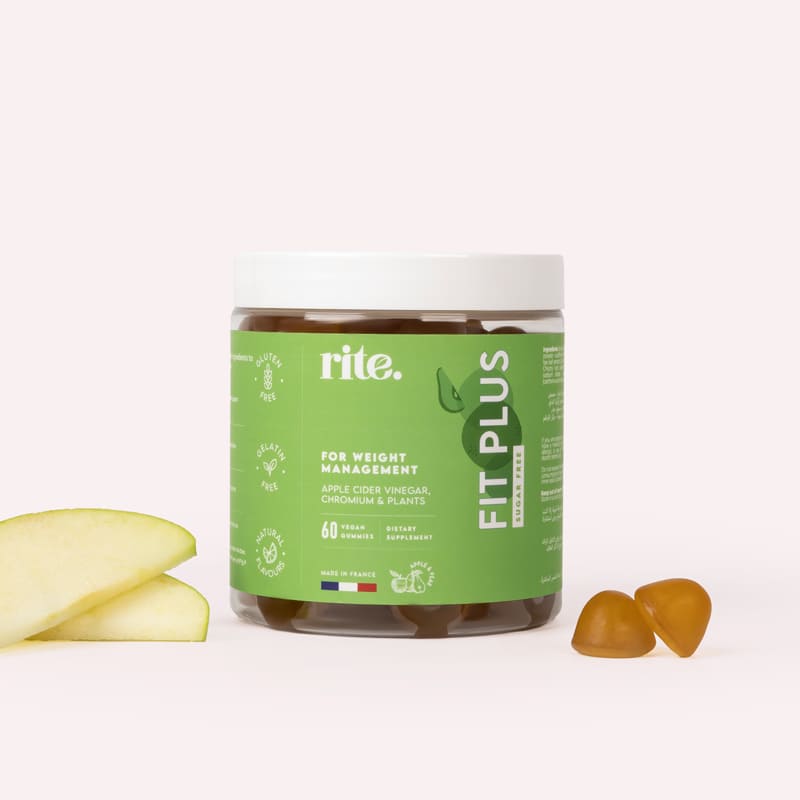 A jar of Rite  Fit Plus  Gummy Multivitamins  next to a sliced green apple on a white background. 