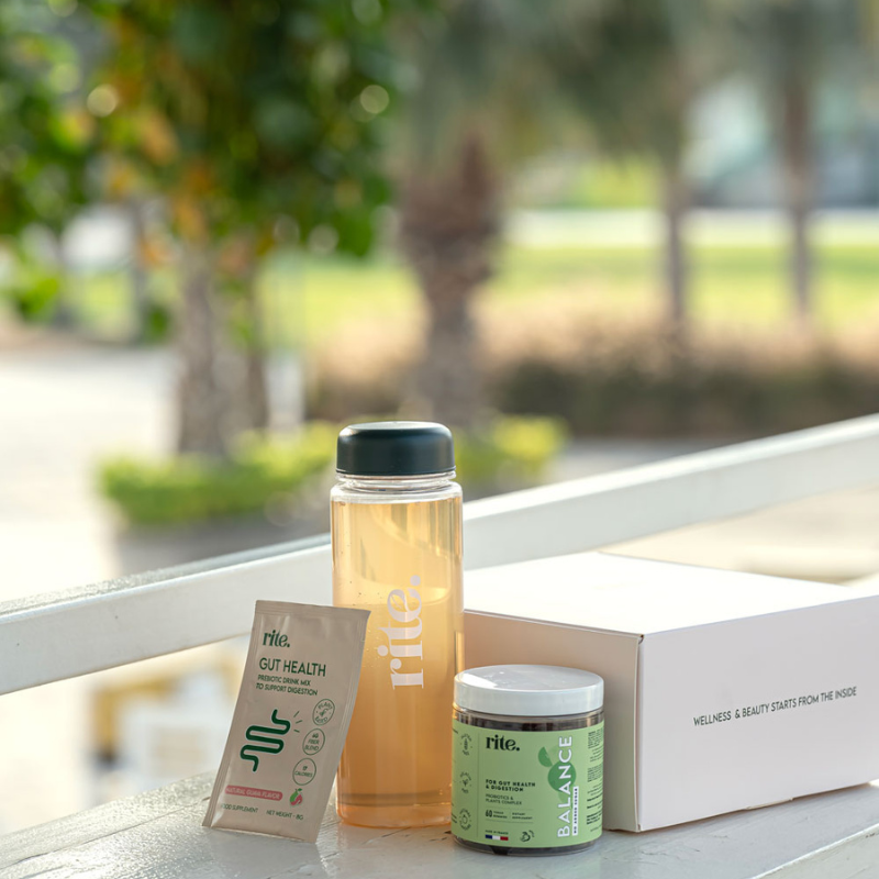 GUT HEALTH & BALANCE GUMMIES KIT, branded bottle, and wellness box placed outdoors, promoting digestive health and daily self-care