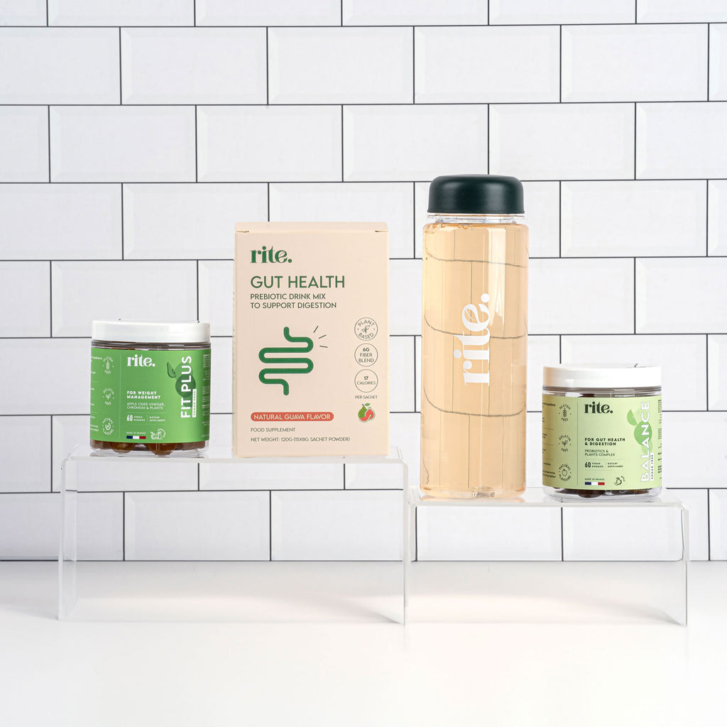 GUT HEALTH products including PREBIOTIC DRINK MIX, FIT PLUS and BALANCE GUMMIES, and a wellness drink BOTTLE arranged on clear stands