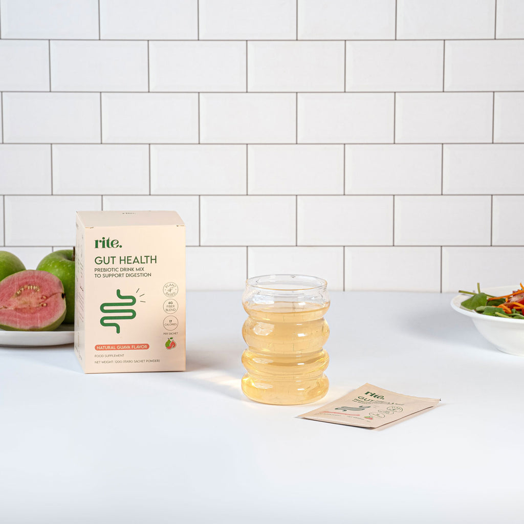 GUT HEALTH prebiotic drink mix box, sachet, and prepared drink in a clear glass, guava flavored to support digestion.