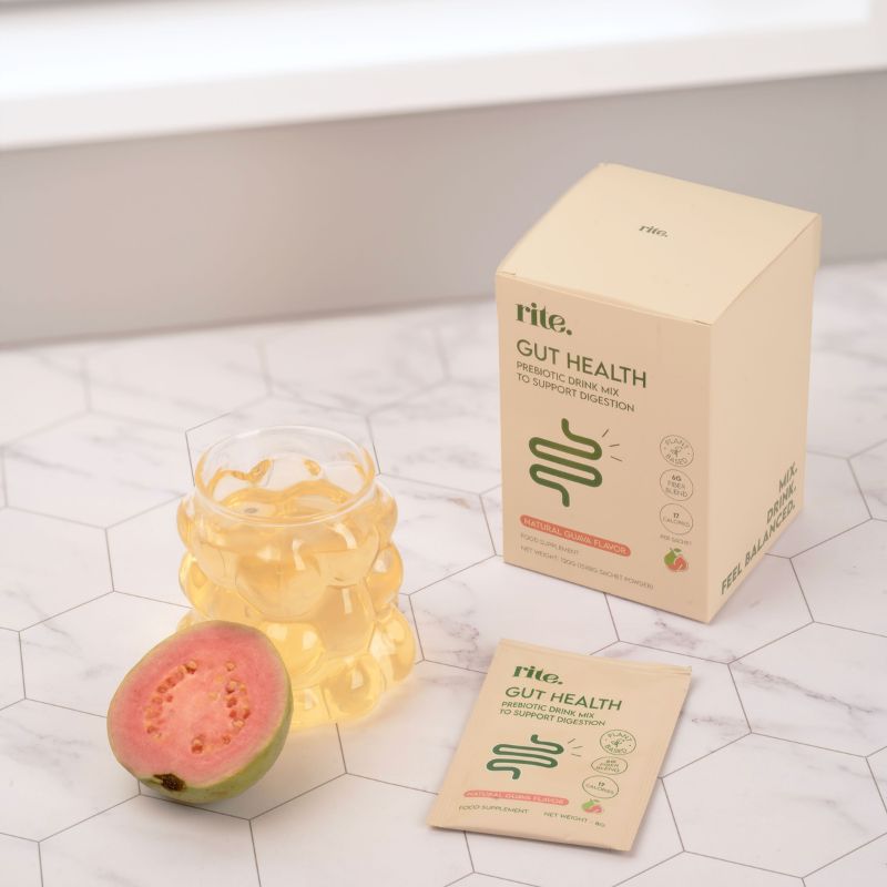 GUT HEALTH sachet, box, guava drink in glass, and fresh guava showing prebiotic supplement for digestion