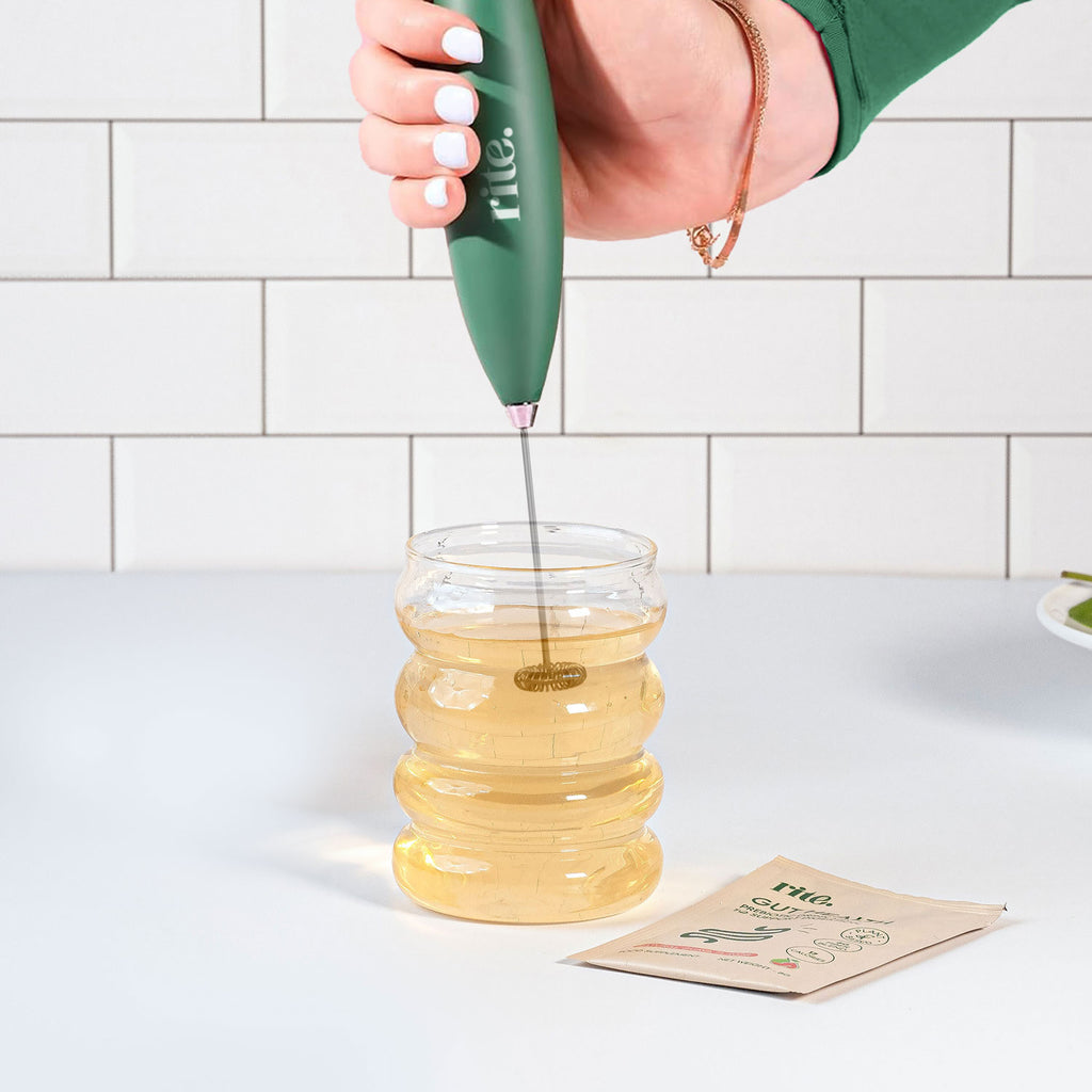ELECTRIC WHISKER blending GUT HEALTH DRINK smoothly in a modern glass for better digestion and easy mixing