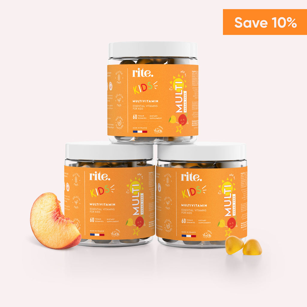 Three jars of Rite Kids Multivitamin gummies stacked on top of each other with a peach on a white background.