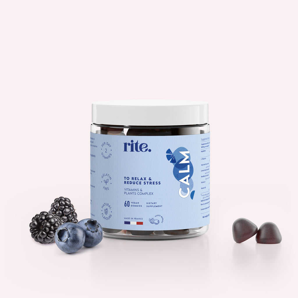 "A jar of Rite CALM Vitamin Gummies next to a blackberry on a white background. "