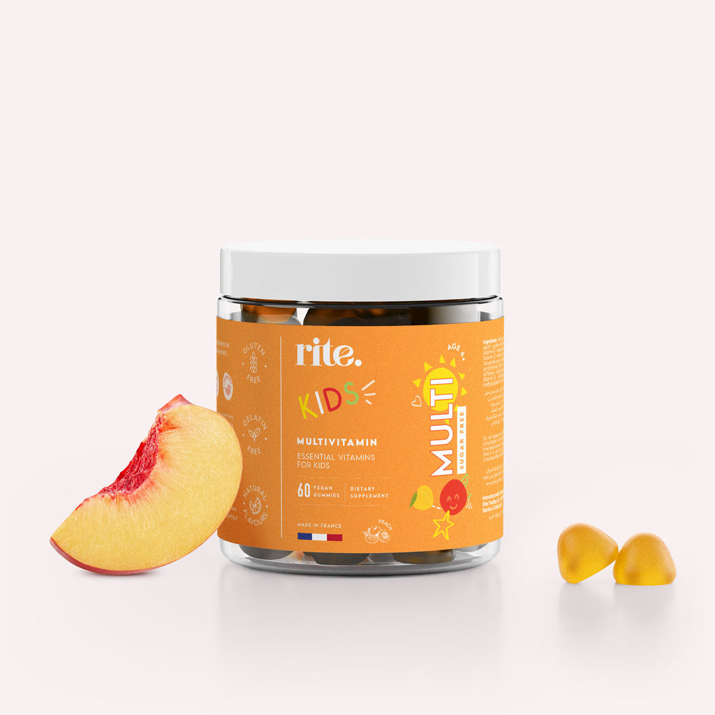 A jar of Rite Multivitamin Sugar Free Gummy Vitamins for Kids sits next to a sliced peach. 