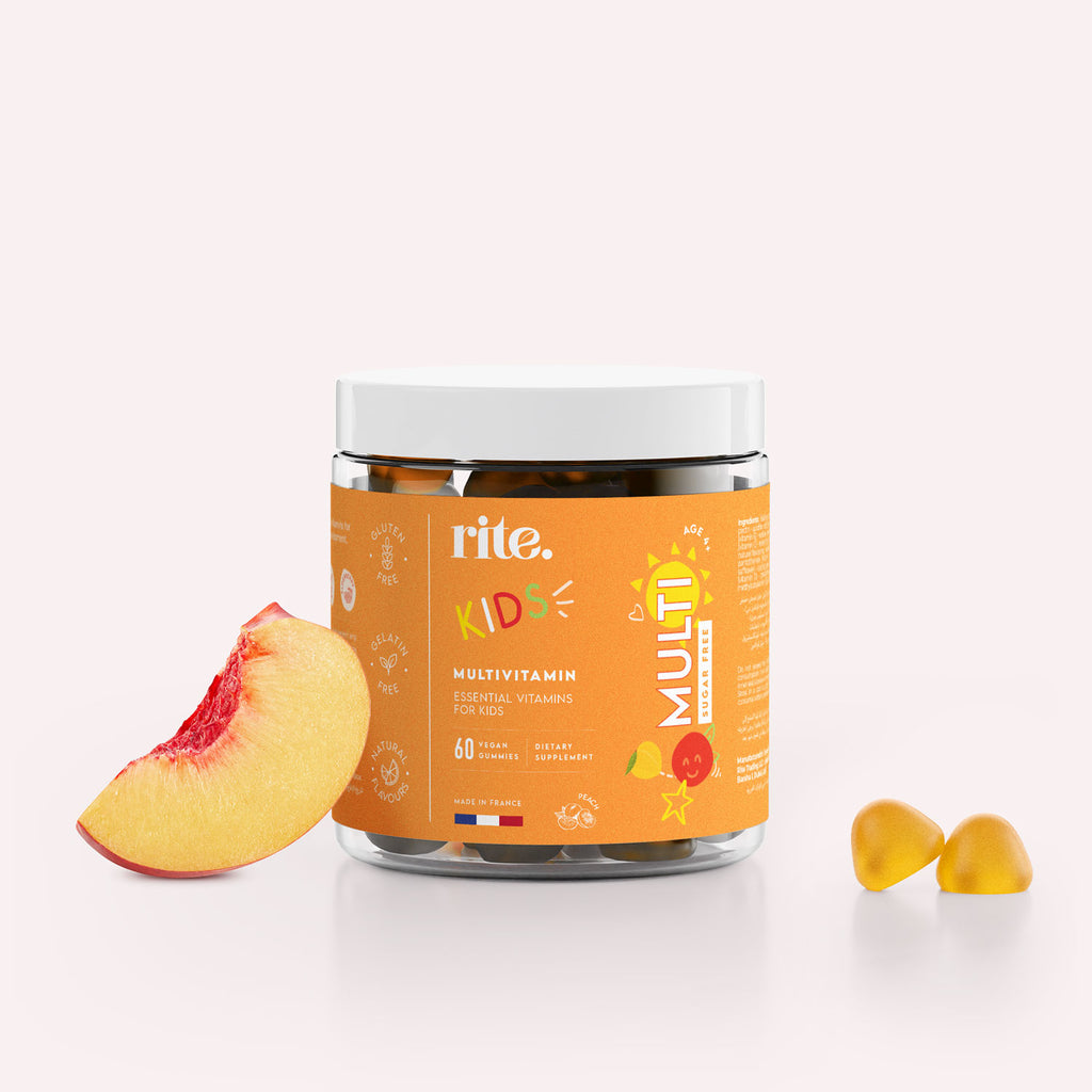 A jar of Rite Multivitamin Gummy Vitamins for Kids sits next to a sliced peach.