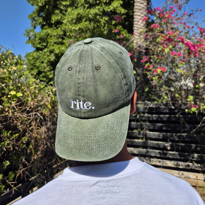 GREEN CAP with white embroidered rite. logo, curved brim, and soft washed fabric for casual wear